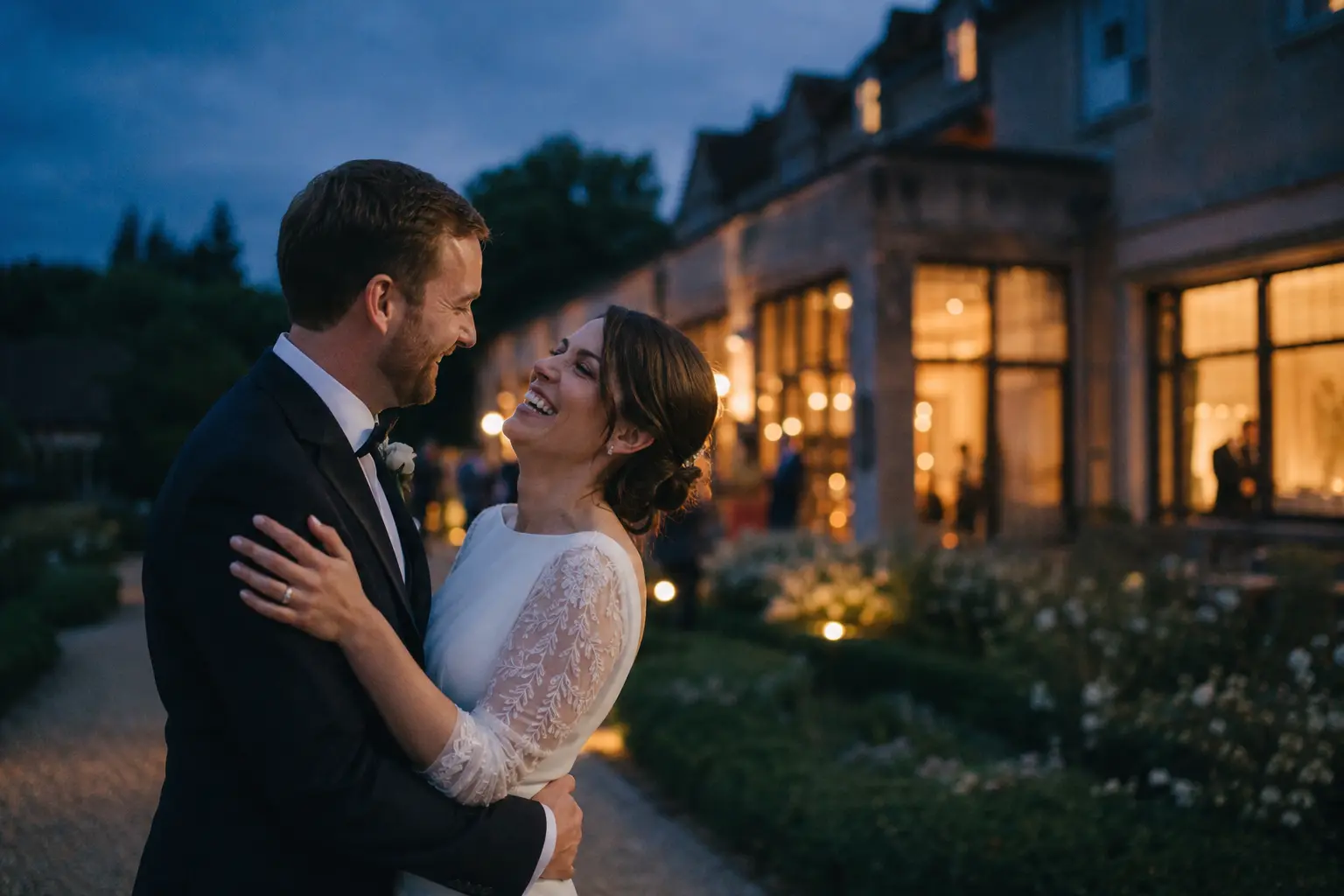 A newly married couple sharing a quiet moment outside their evening reception
