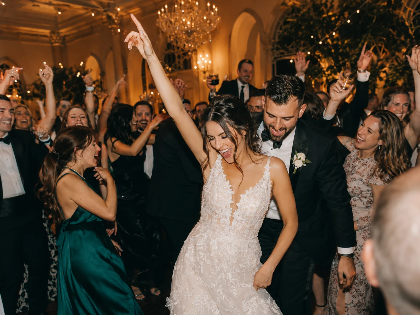 A newly married couple celebrating together on a lively dancefloor