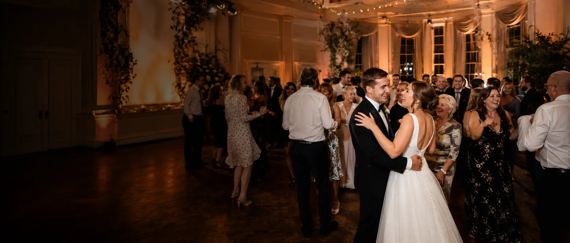 A newly married couple enjoying a full dancefloor with family and friends